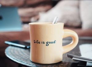 brown ceramic mug on blue and white ceramic plate